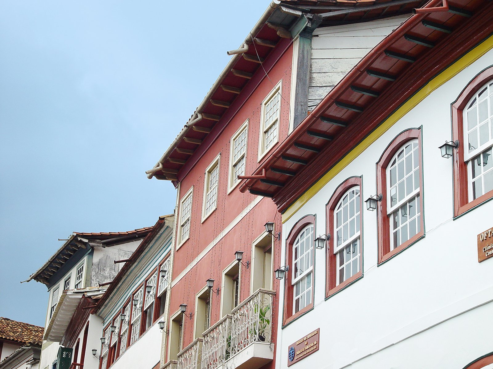 the side of a building with red and white windows