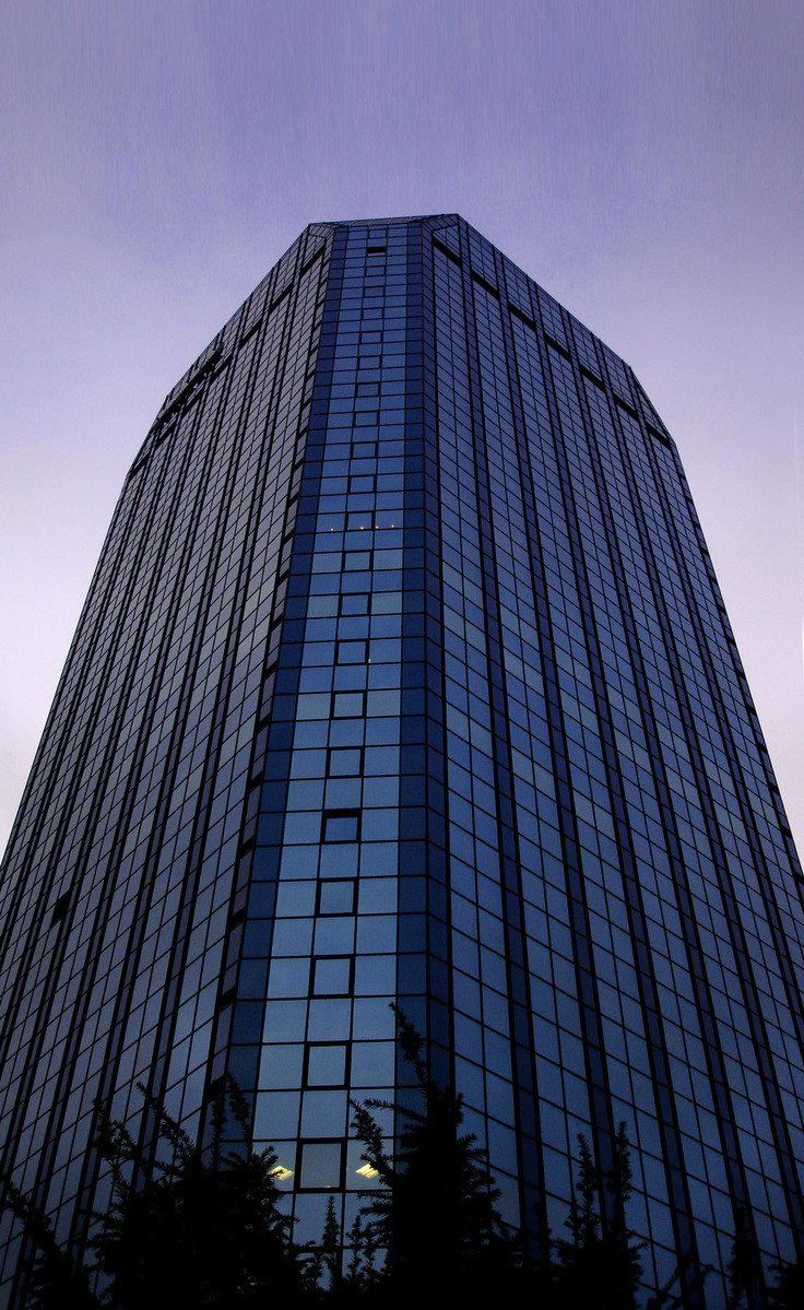 a very tall building with an upward reflection