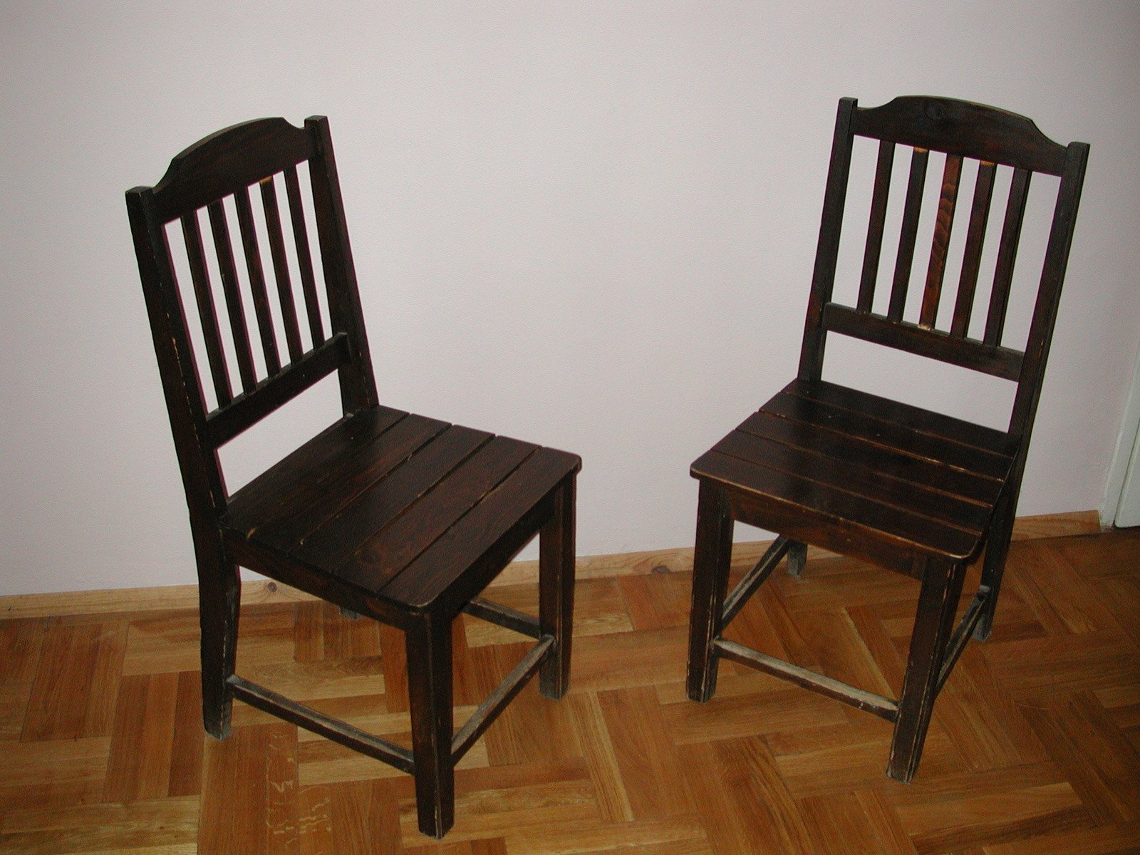 two chairs side by side, one with no legs and one without a back