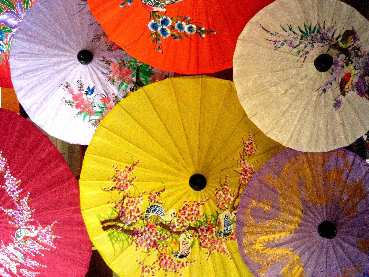 many colorful, umbrellas are arranged close together
