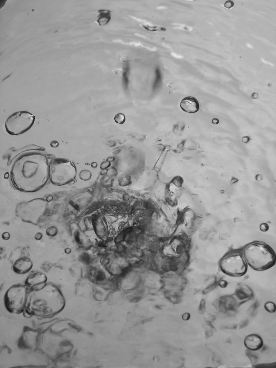 water is boiling on top of a black and white picture