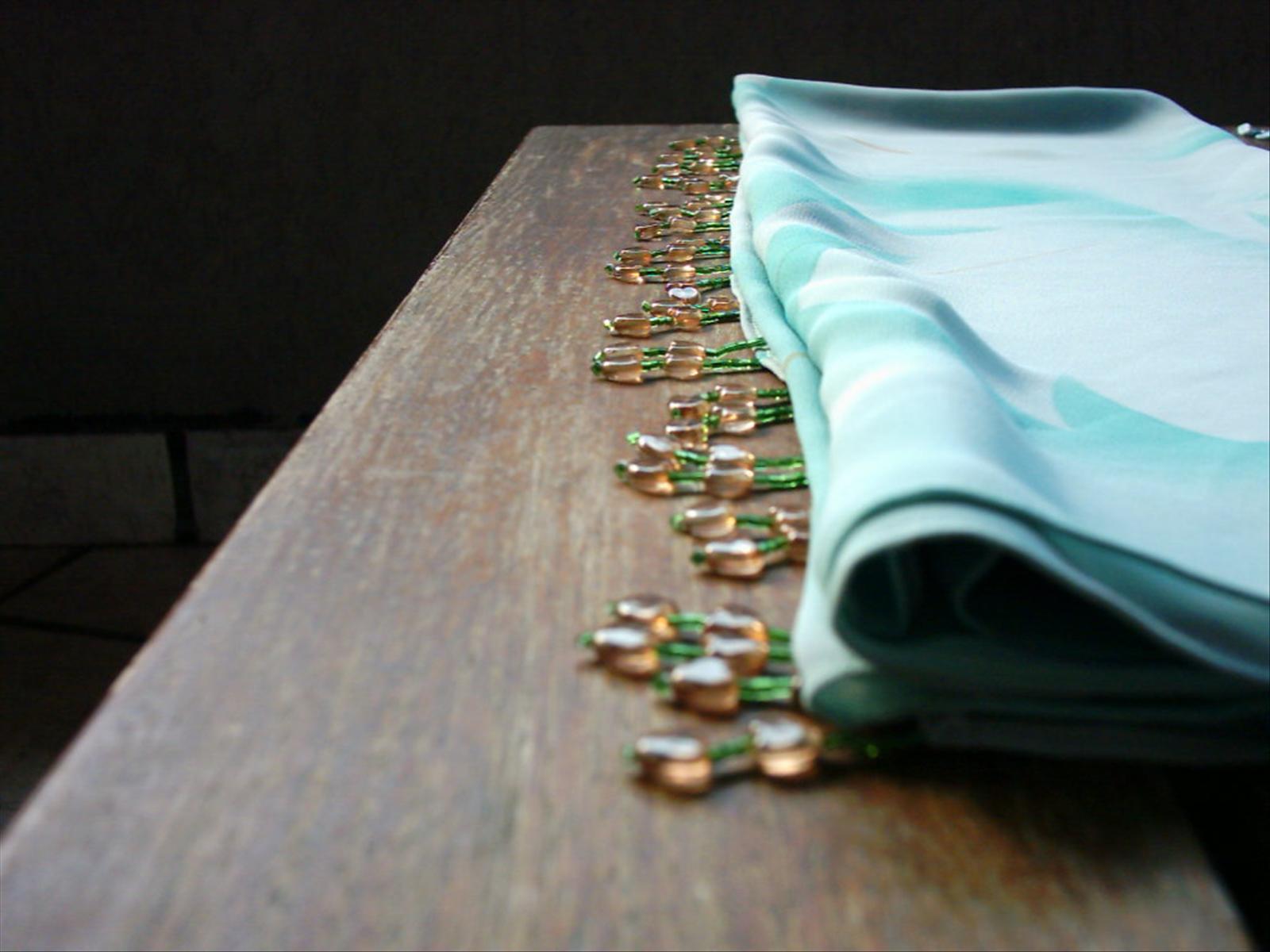 green fabric sitting on top of a wooden table