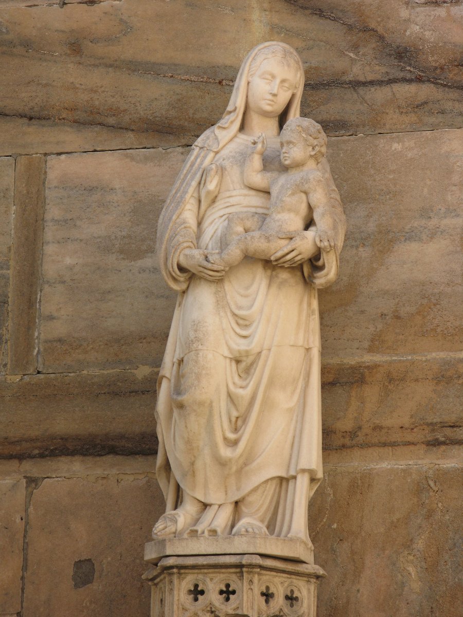 a marble sculpture of the virgin mary holding a child
