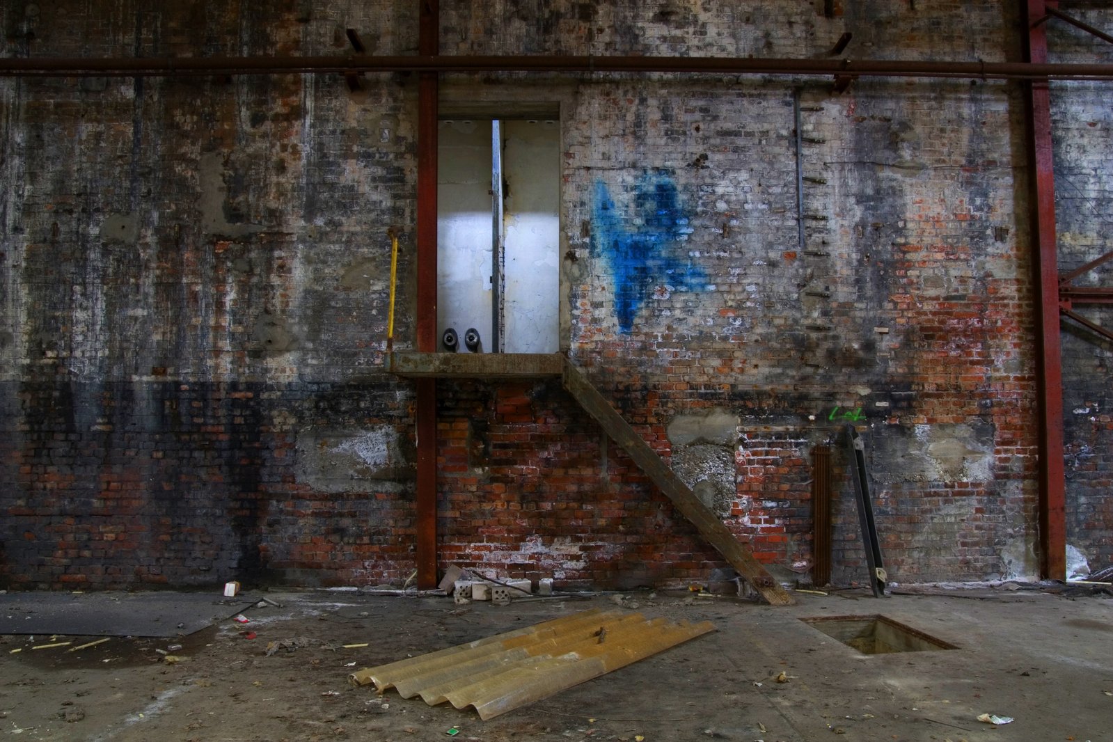an empty room in a building with graffiti on the wall and steps painted red