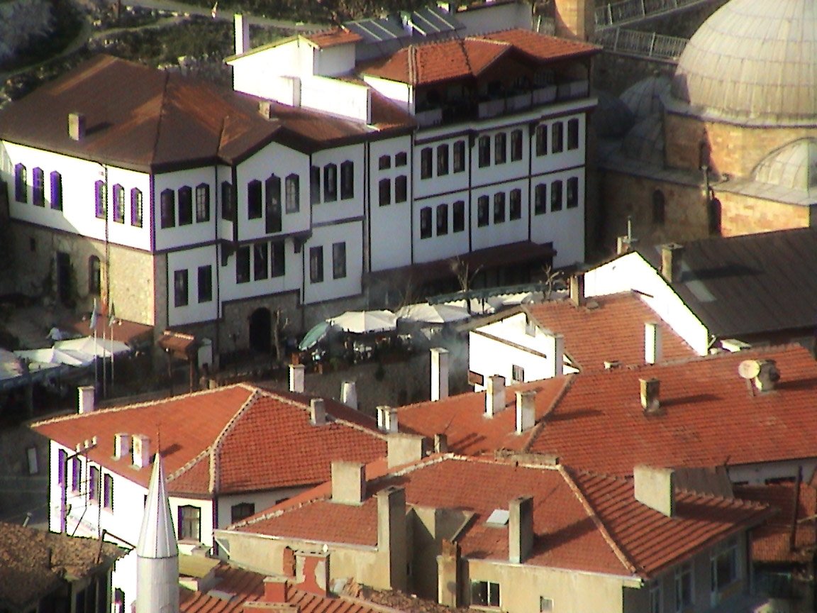 a group of buildings with red tile roofs