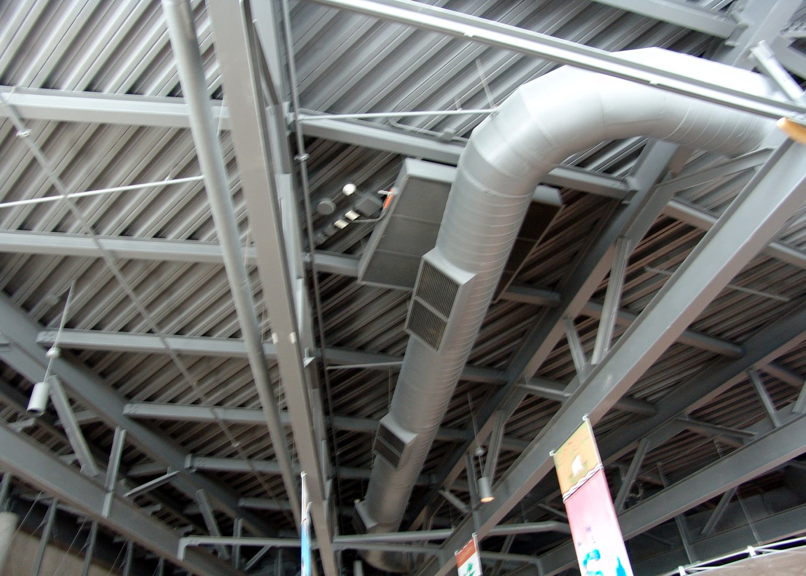 large silver pipes are shown on the ceiling in the building