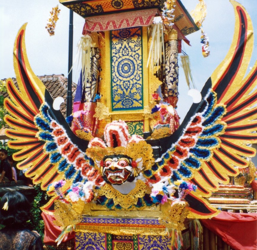 a brightly colored, elaborately decorated float that looks like a bird's head