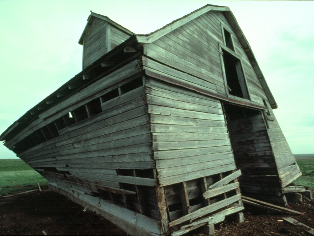 an old wooden house falling apart in a rural country