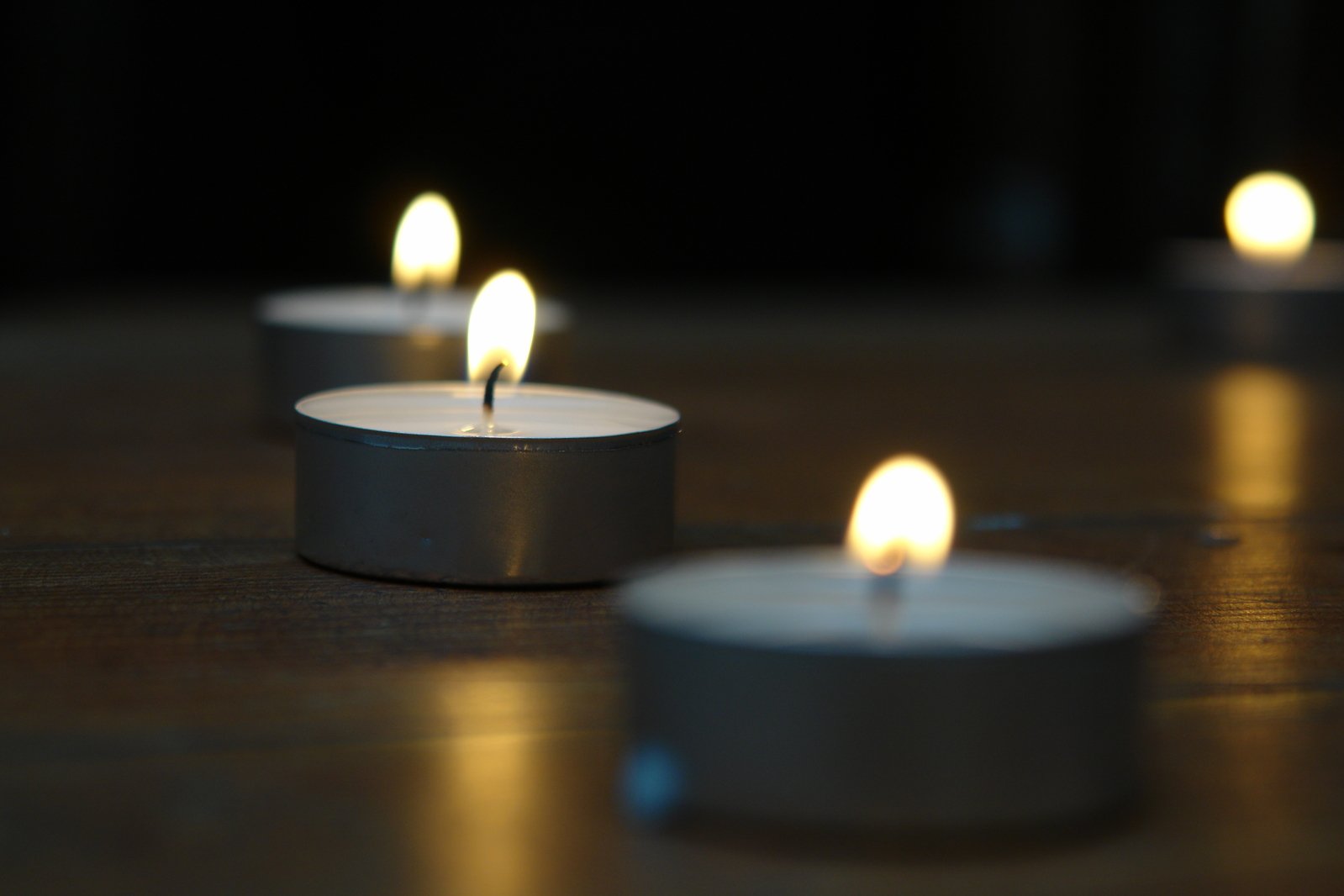 lit candles sit on top of a table