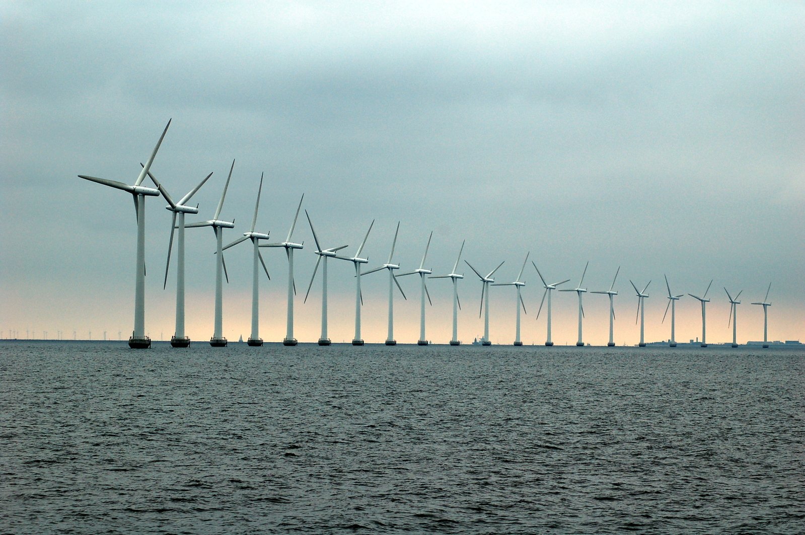 wind farm on the ocean with multiple windmills