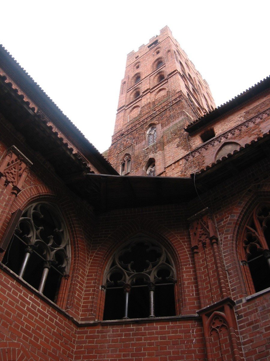 an old cathedral is shown with windows and a clock tower