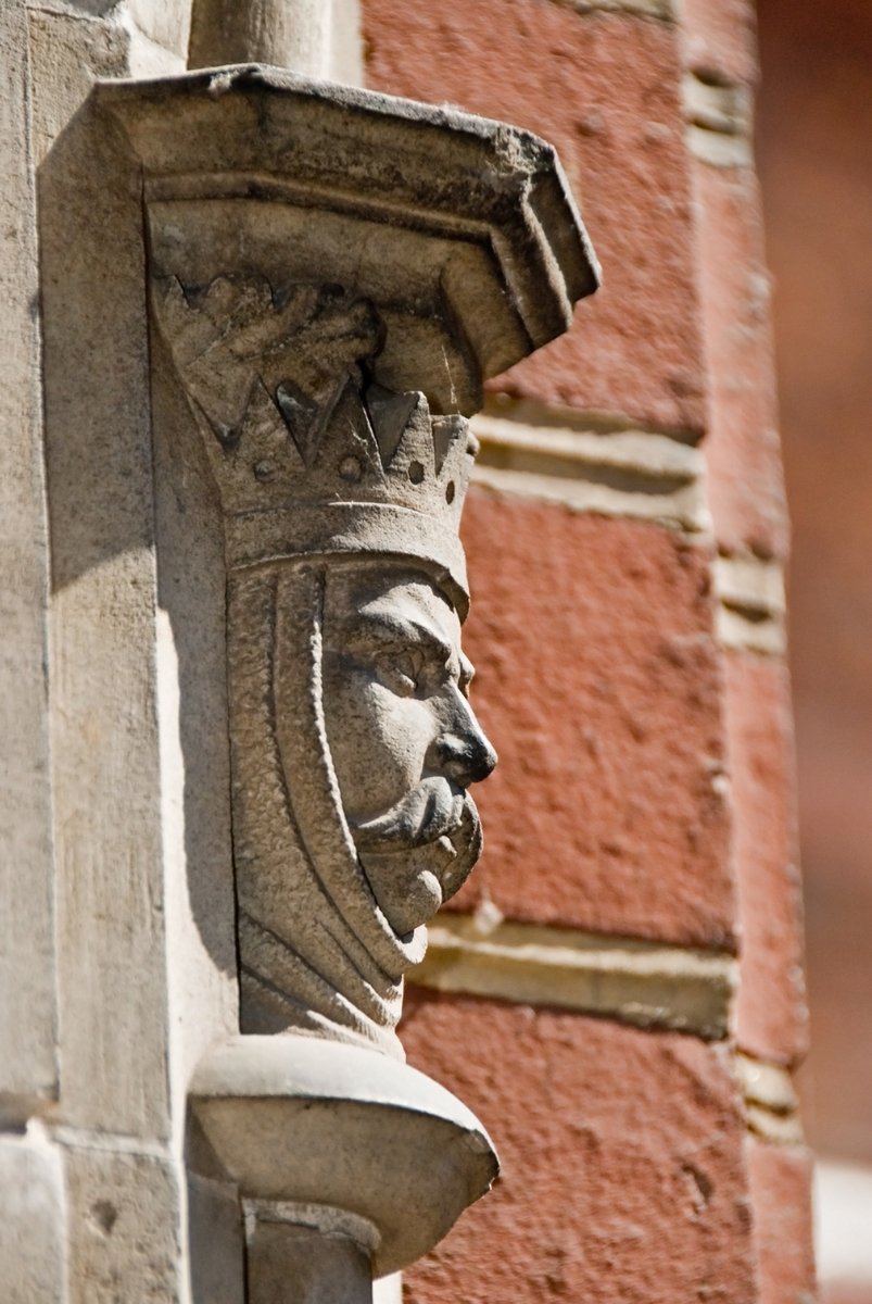 an ornate head on the side of a building