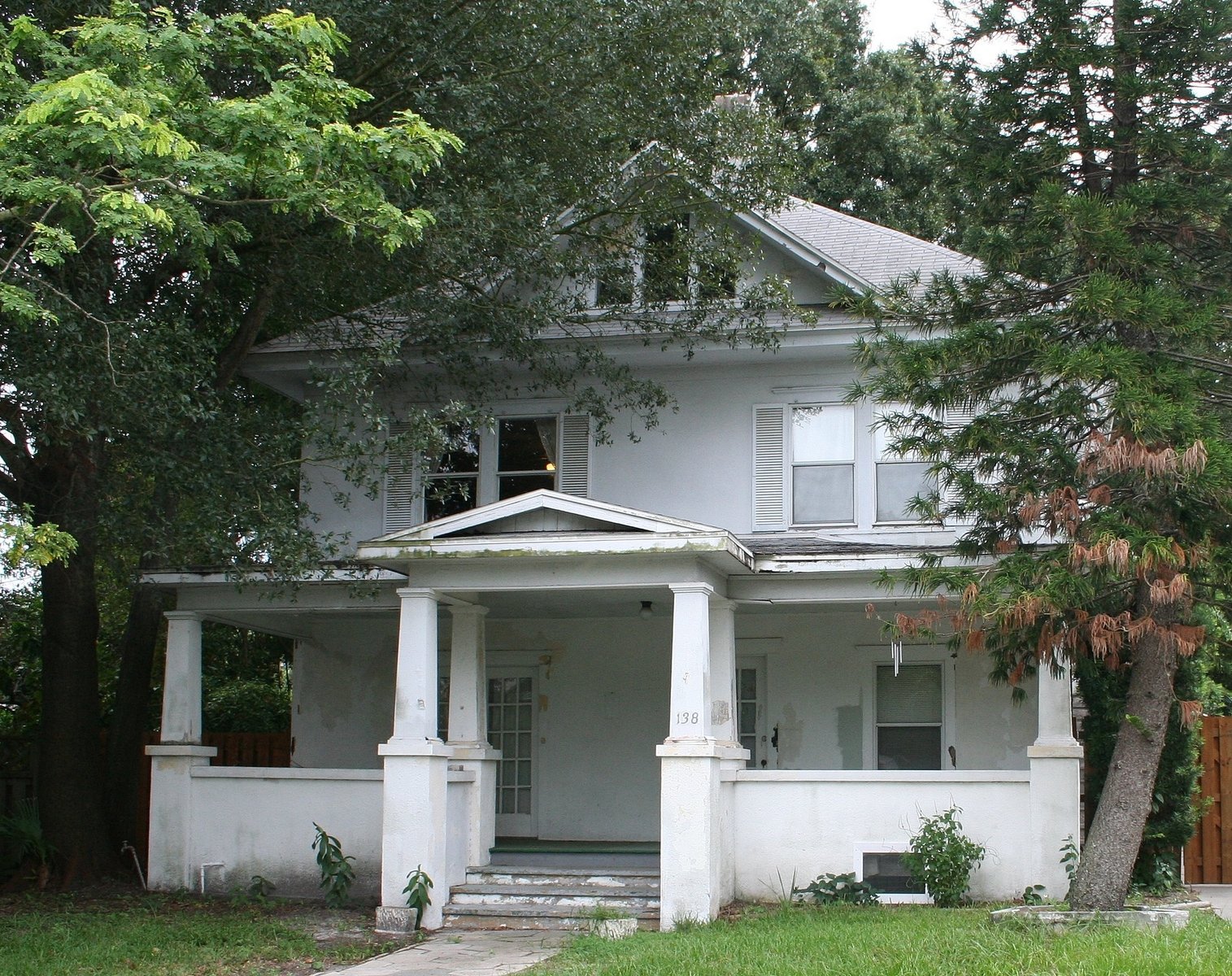 a big white house with an old fashioned porch
