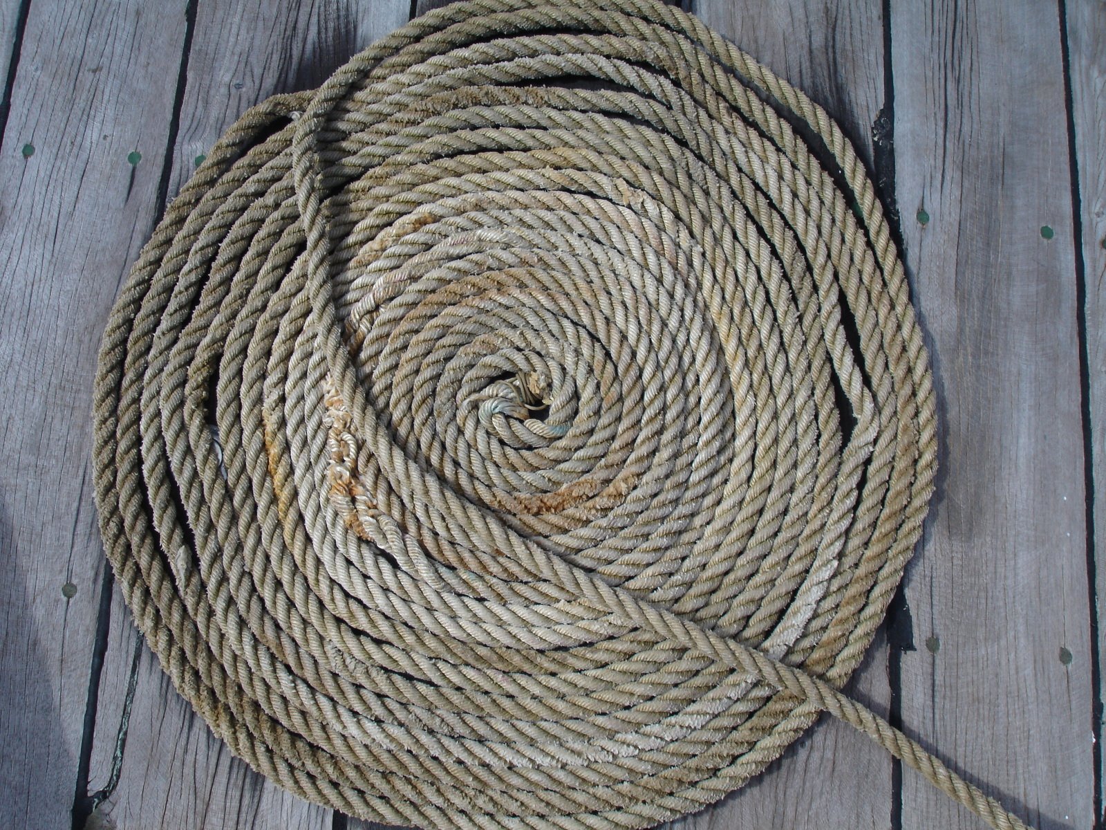 a close up of a rope on wooden floors
