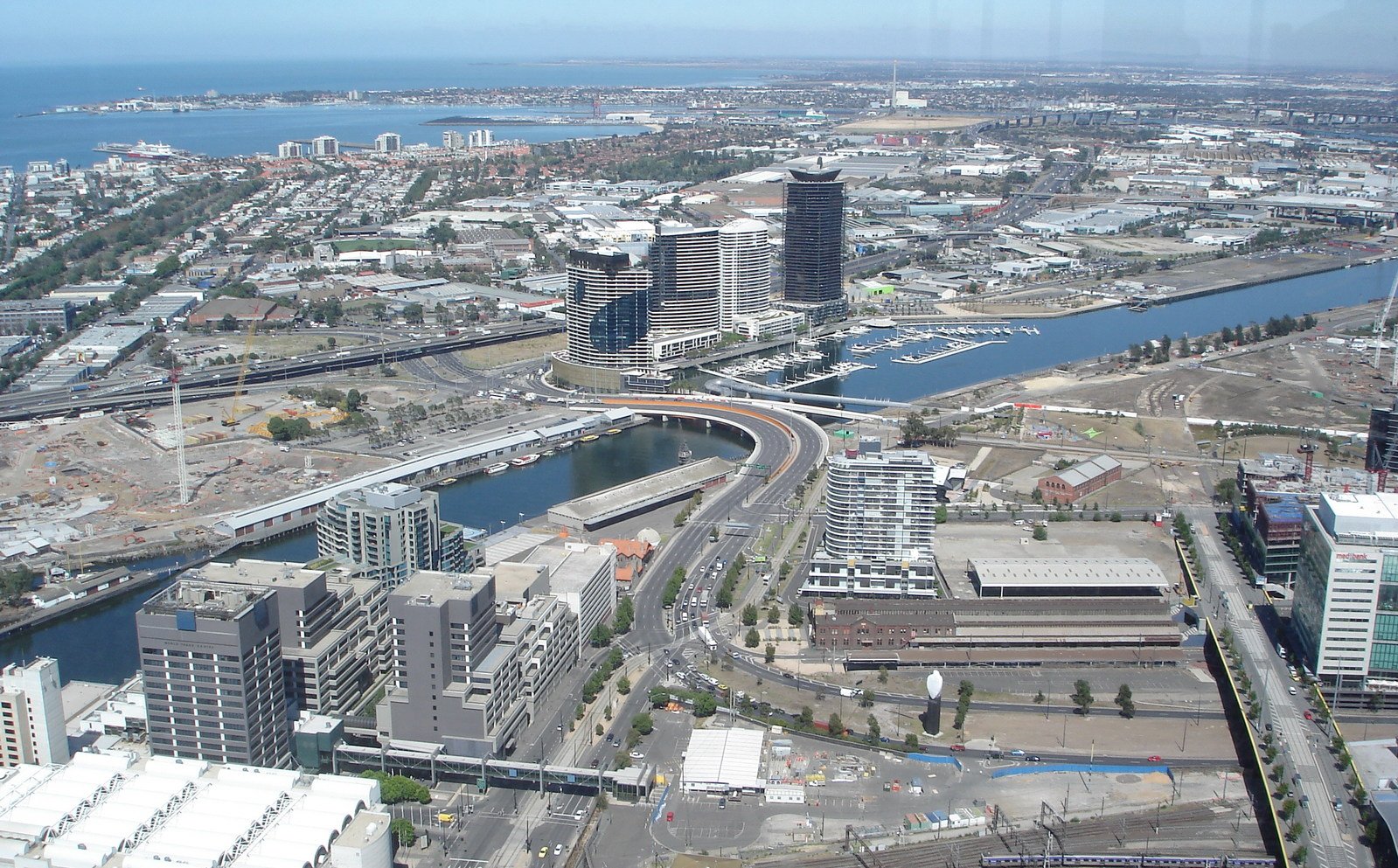 a bird's eye view shows a river, buildings, and the sea