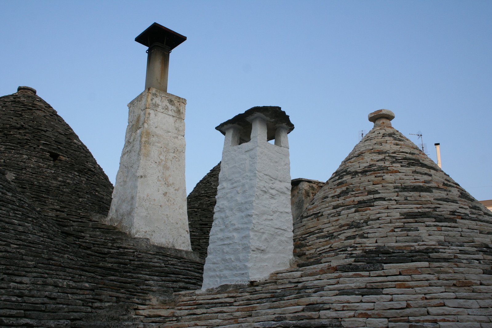 this is a po of two old chimneys on stone walls