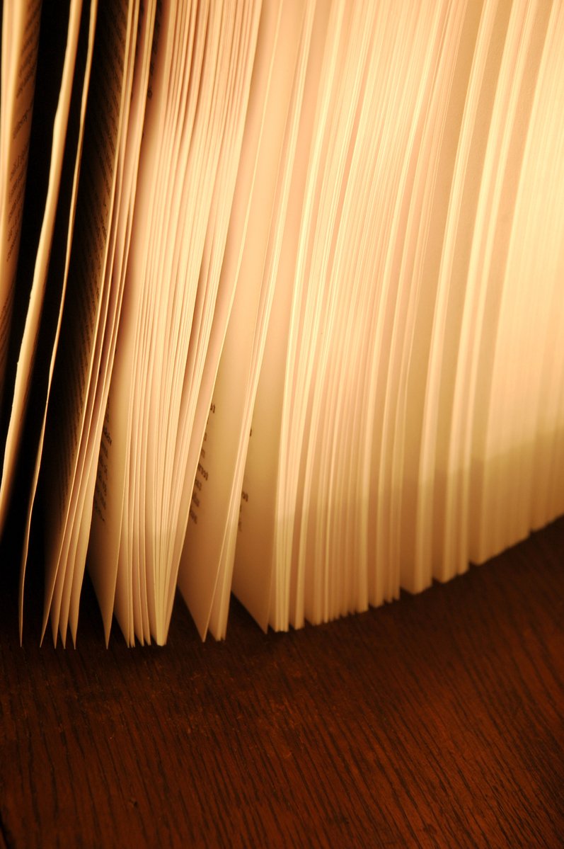 a close up of a stack of books on a desk