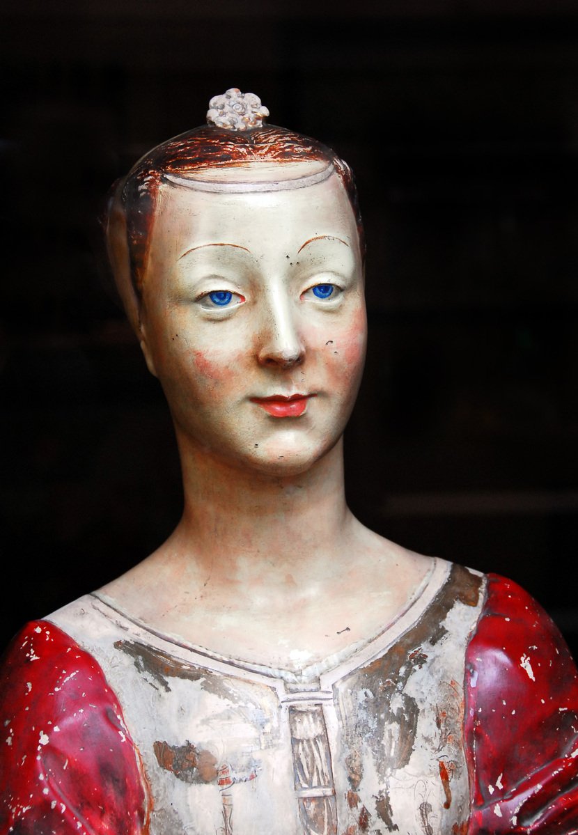 a close up of a sculpture with a strange head