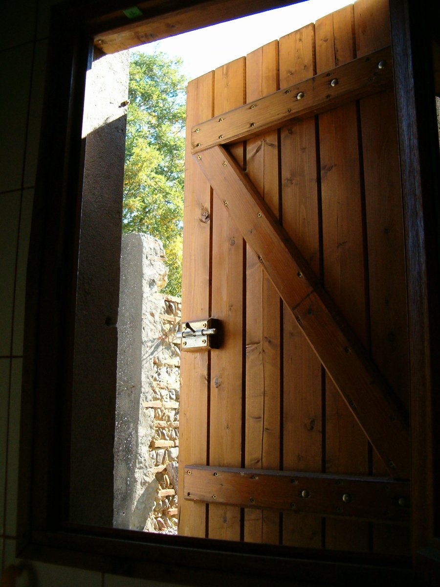 an open door is shown with a stone wall