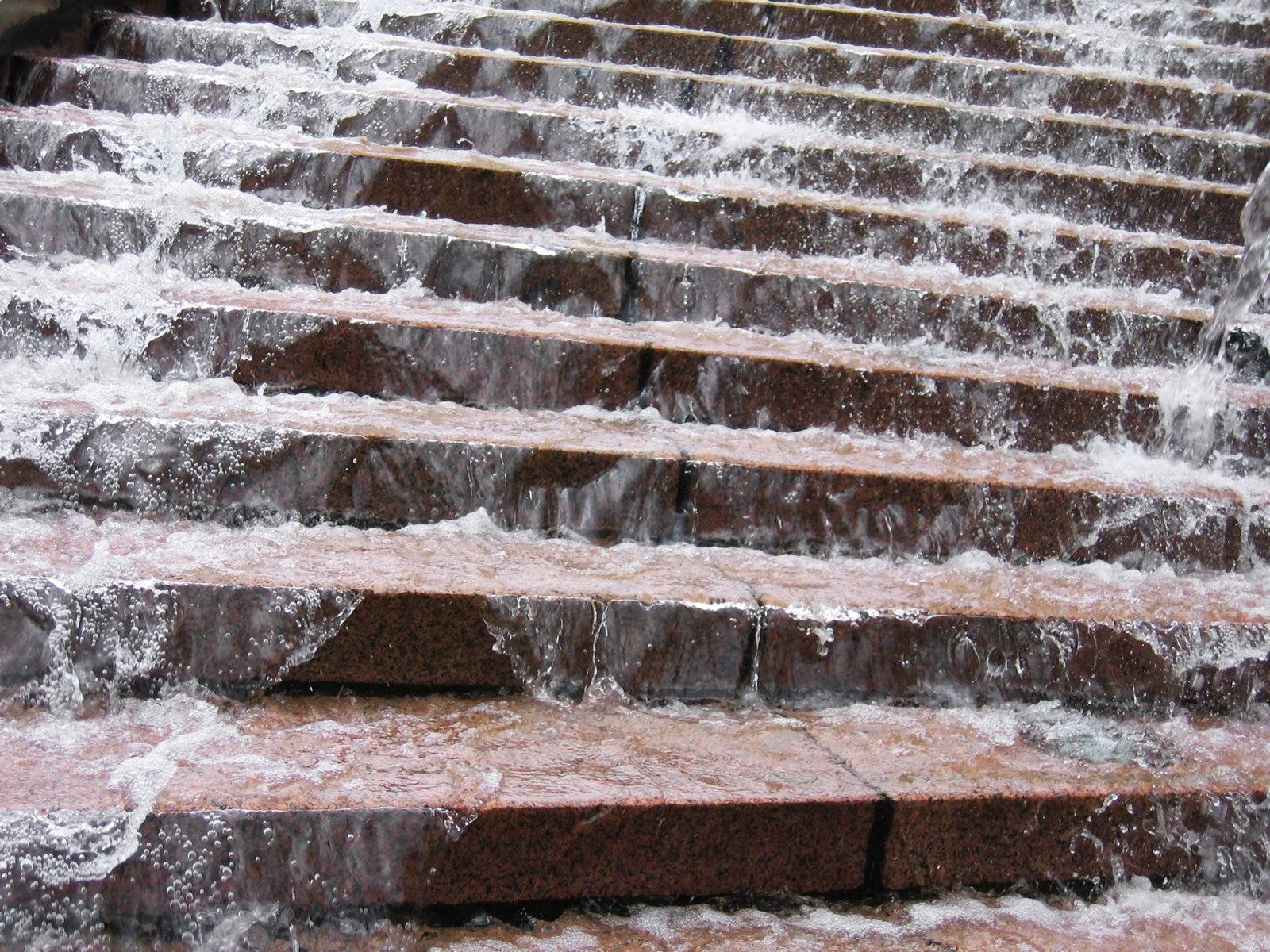 a water front with many steps covered in a brown tile