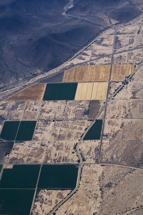 an aerial view of agricultural land in a mountainous region