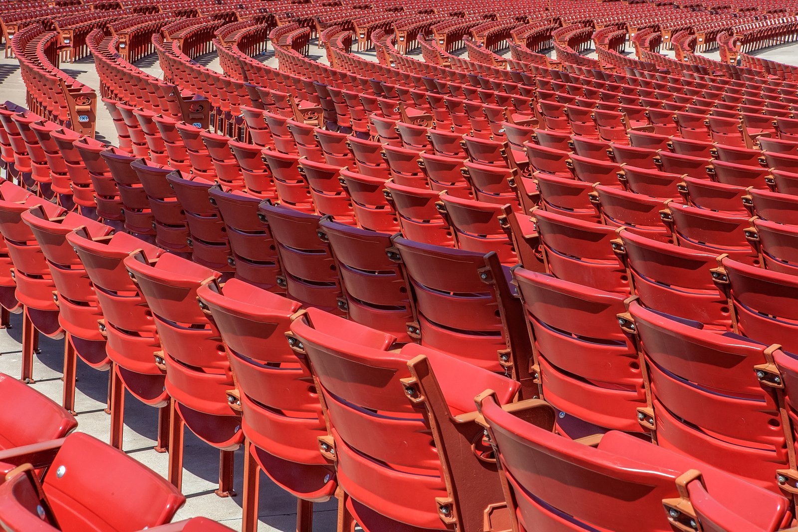 rows of empty red chairs lined up next to each other