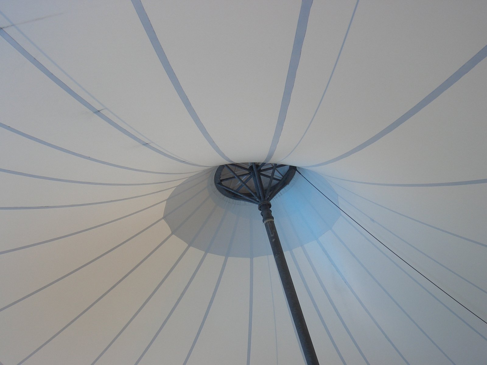 a large umbrella covering with lines coming down from it
