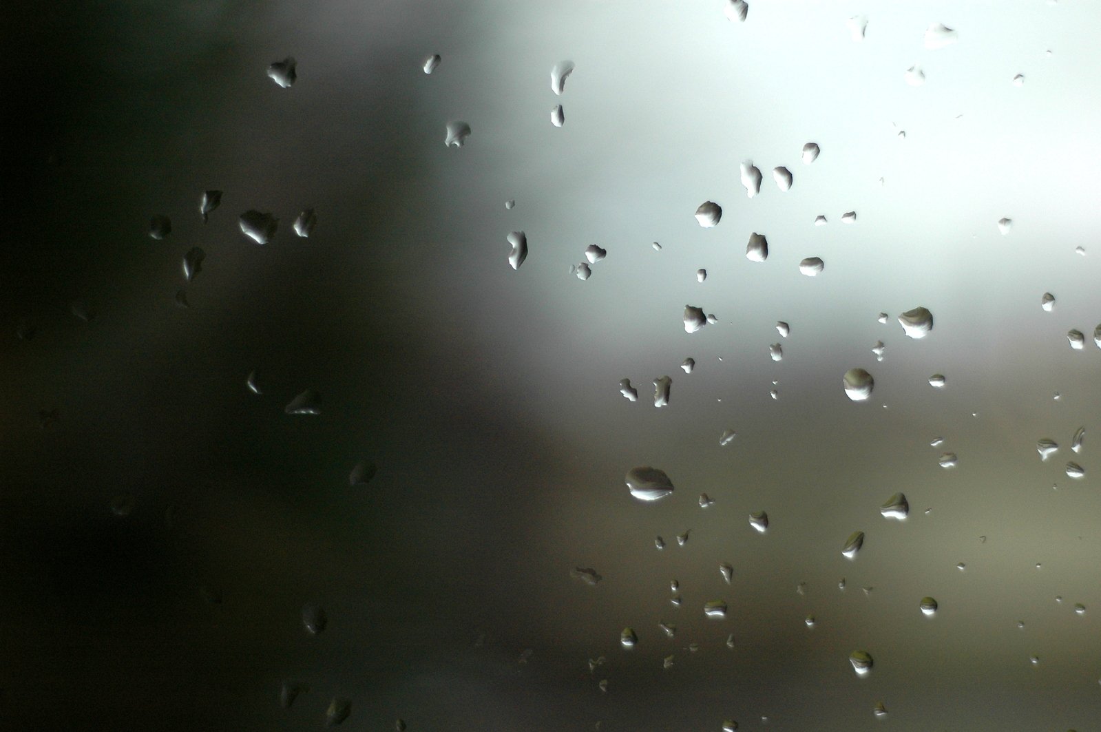 a window covered in rain and lots of drops