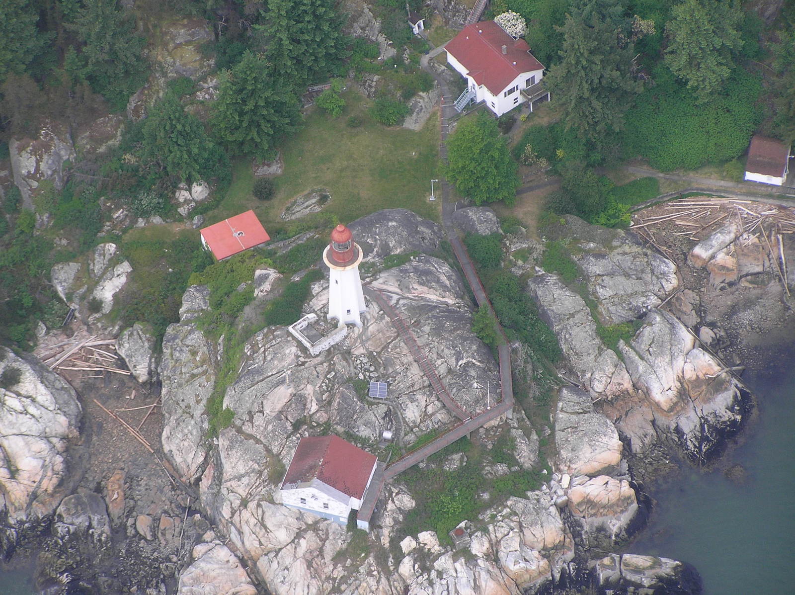 aerial view of several red roofs and a large rock