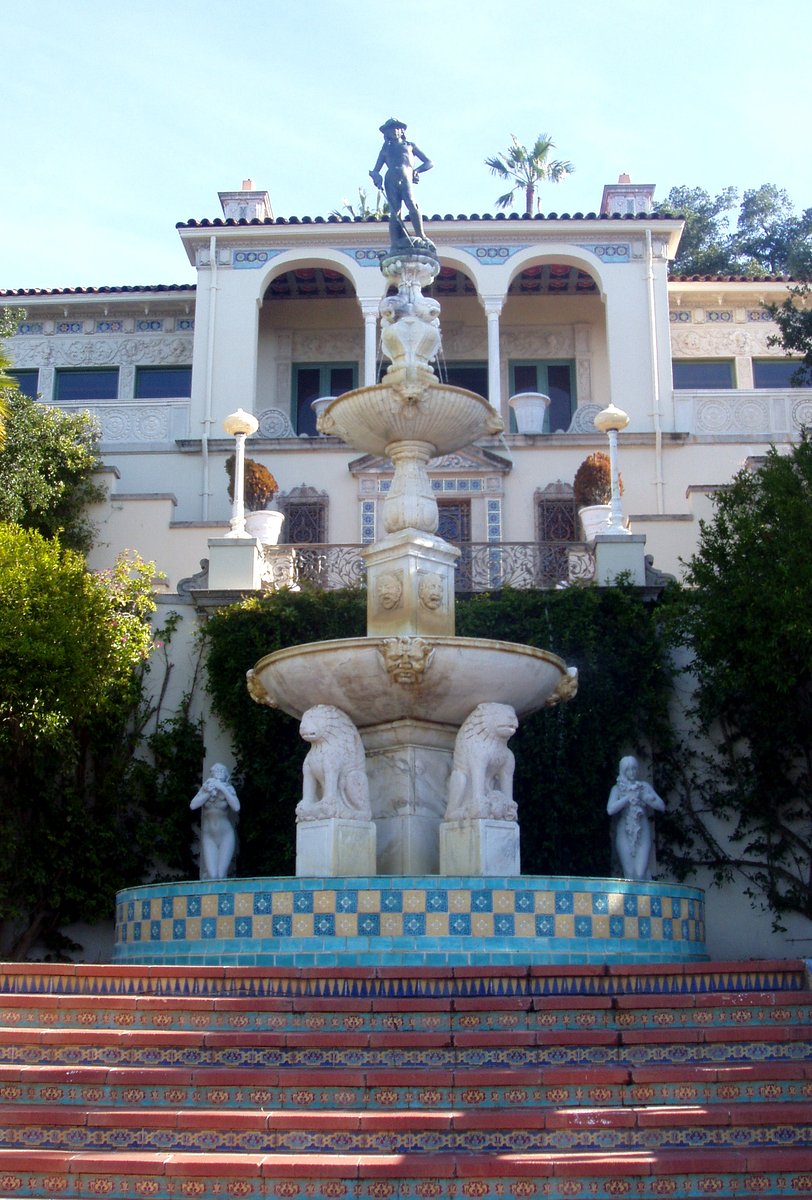 a fountain in front of an elegantly tiled building