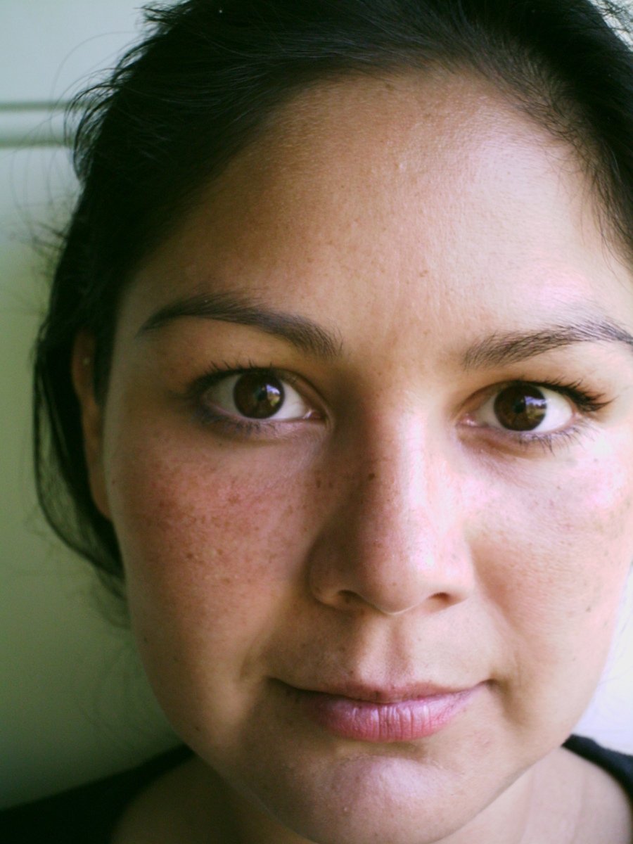 a woman with freckled hair staring at the camera