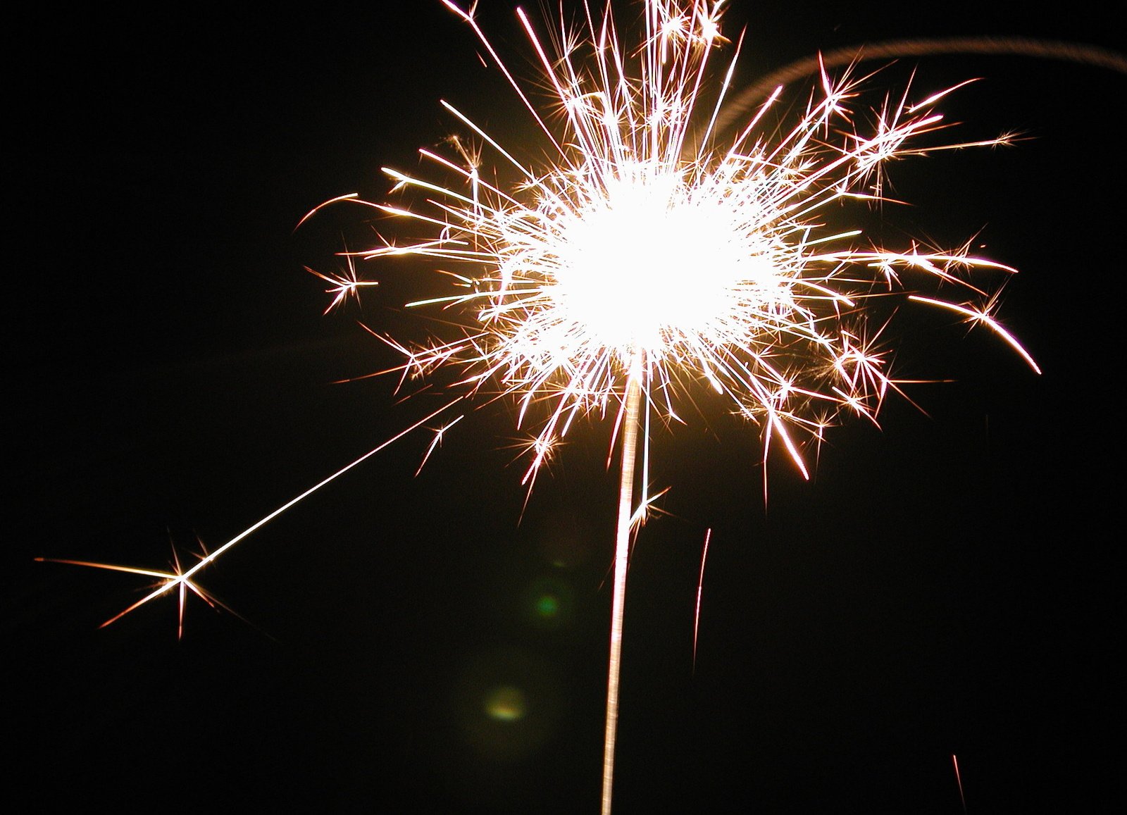 a bright fireworks is bursting against a black background