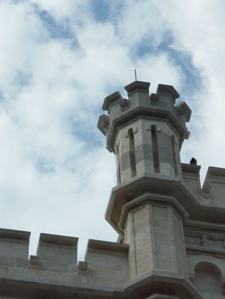 a view of the top of a tower in front of a cloudy sky