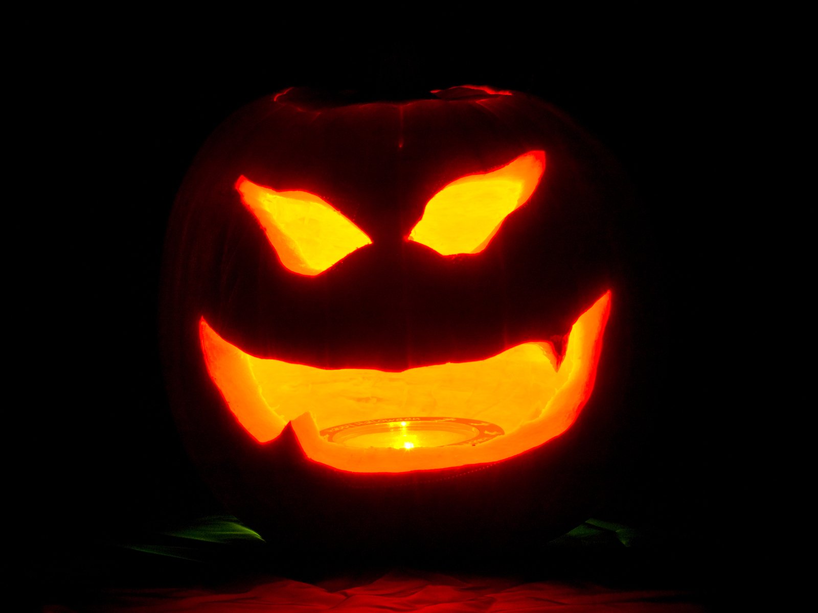a carved pumpkin lit up with candle light