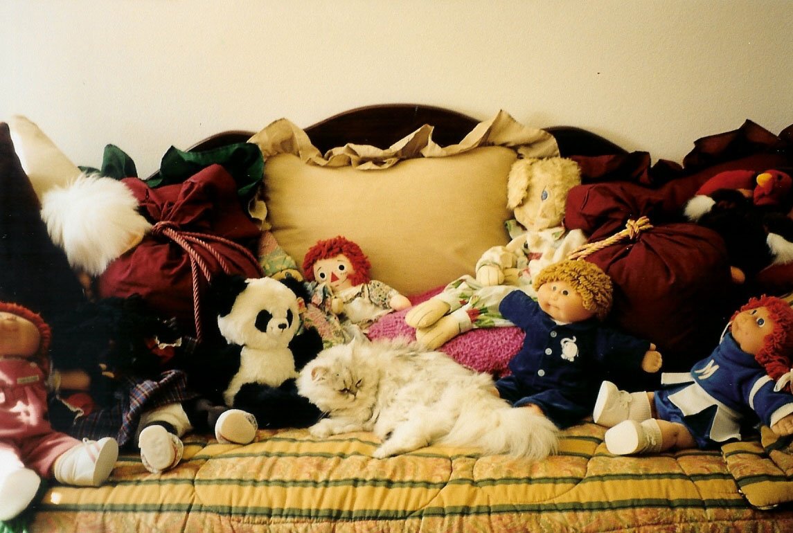 a lot of stuffed animals on the bed