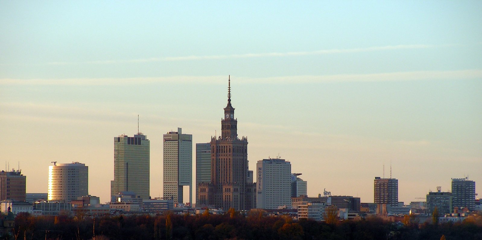 the city skyline has a clock tower above it