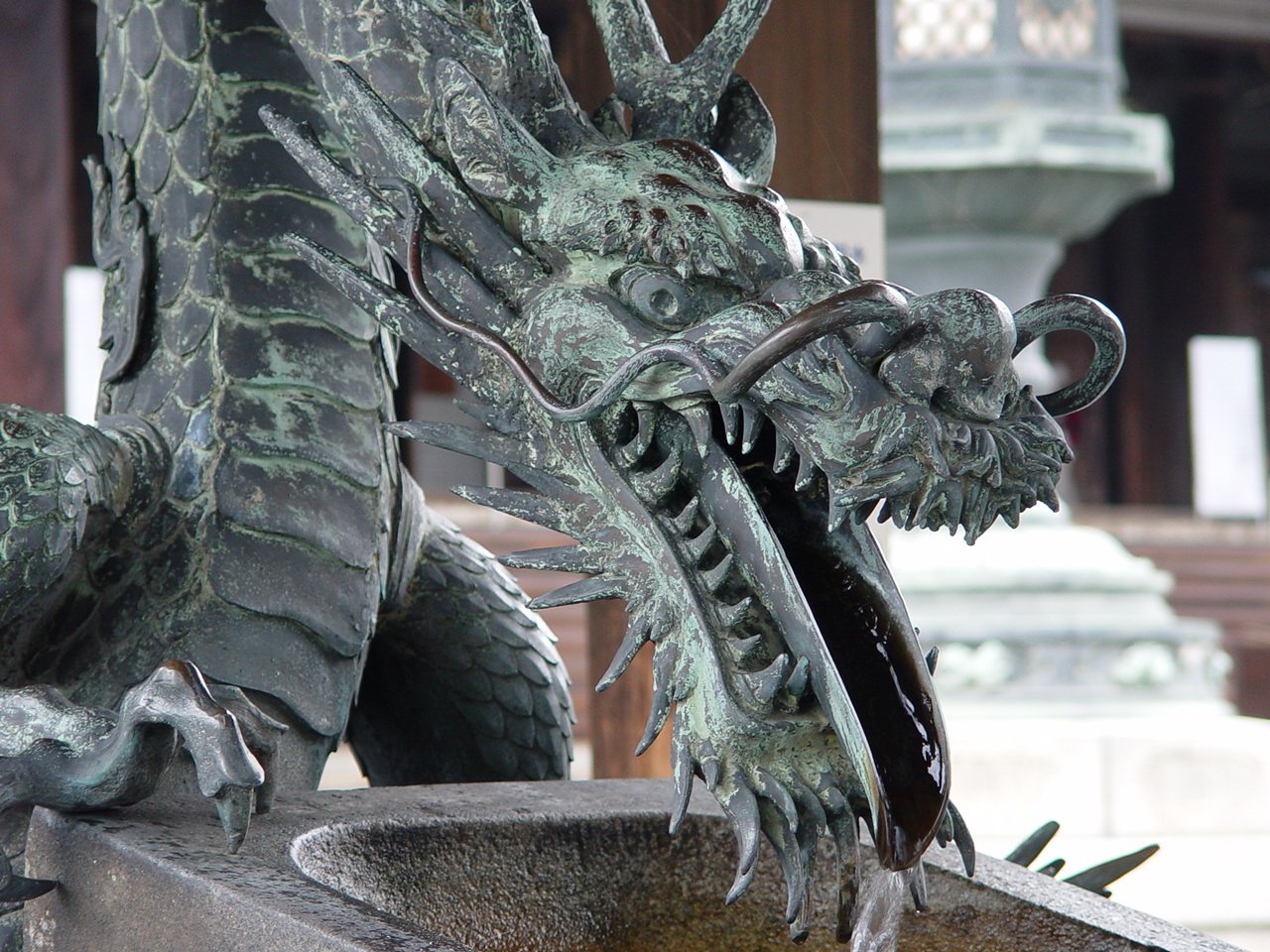 a statue sitting in front of a fountain