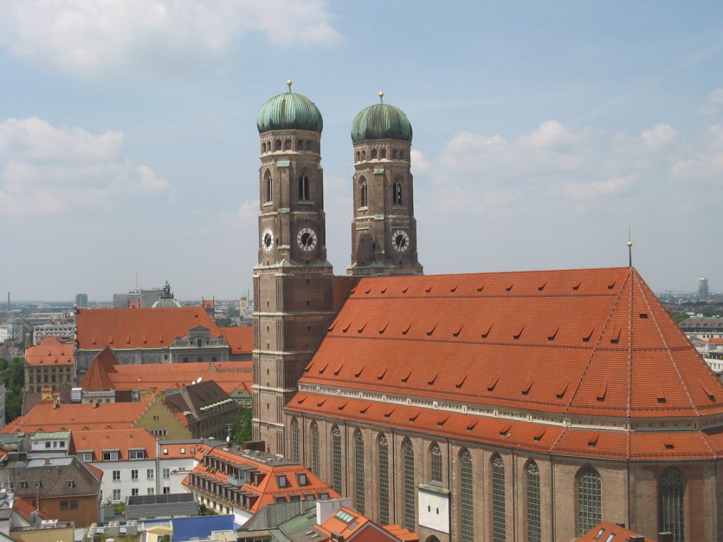 two towers with domes above some buildings