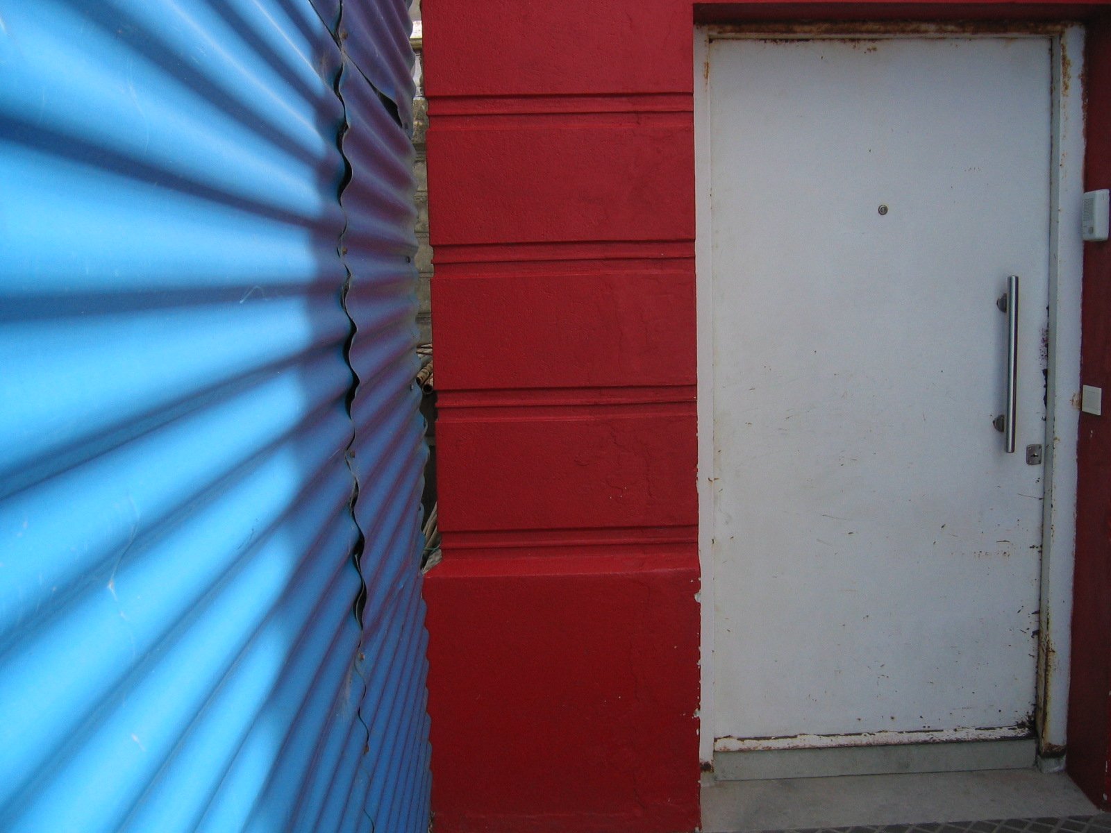 two red walls with blue and white striped doors