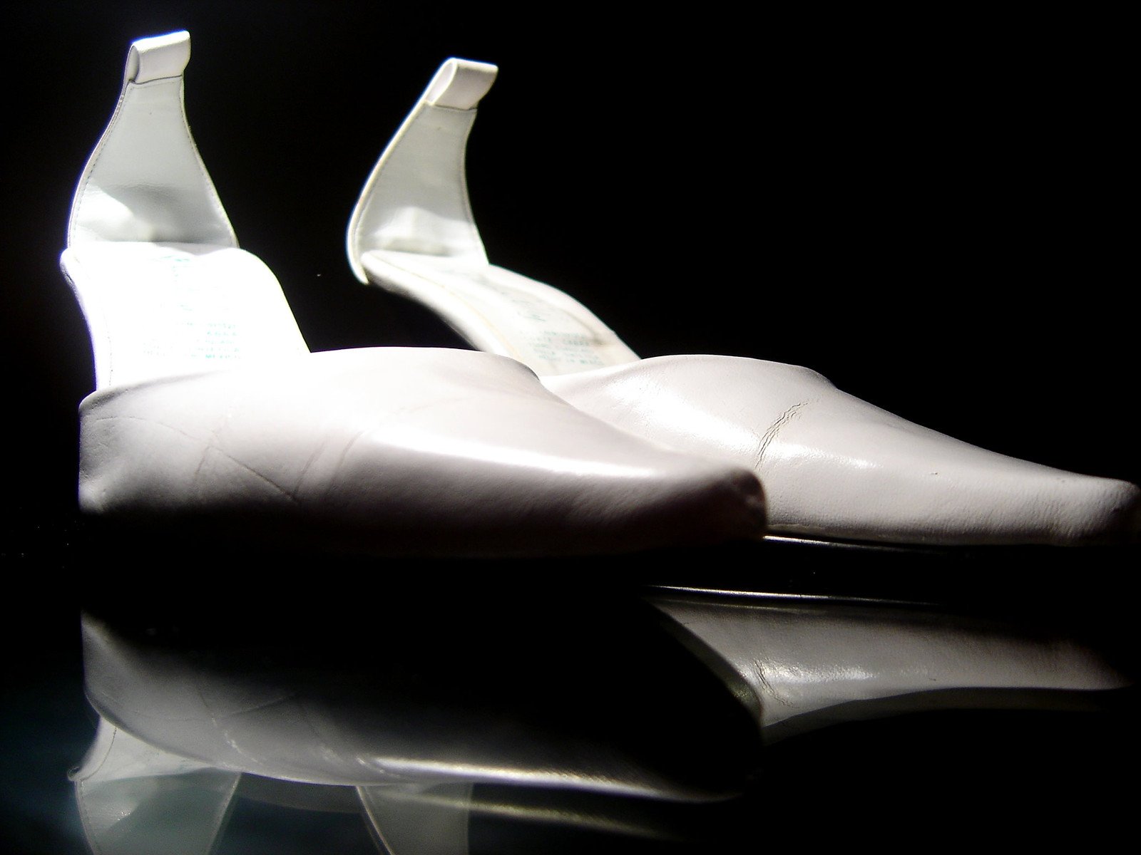 a pair of white shoes sitting on top of a table