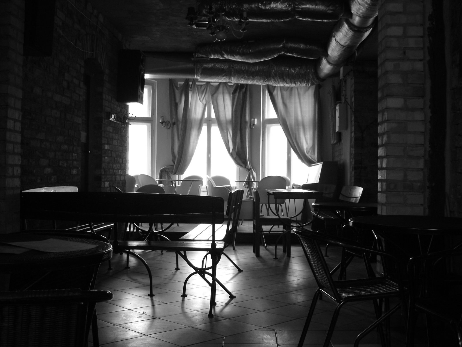 dining area with several tables and chairs in black and white
