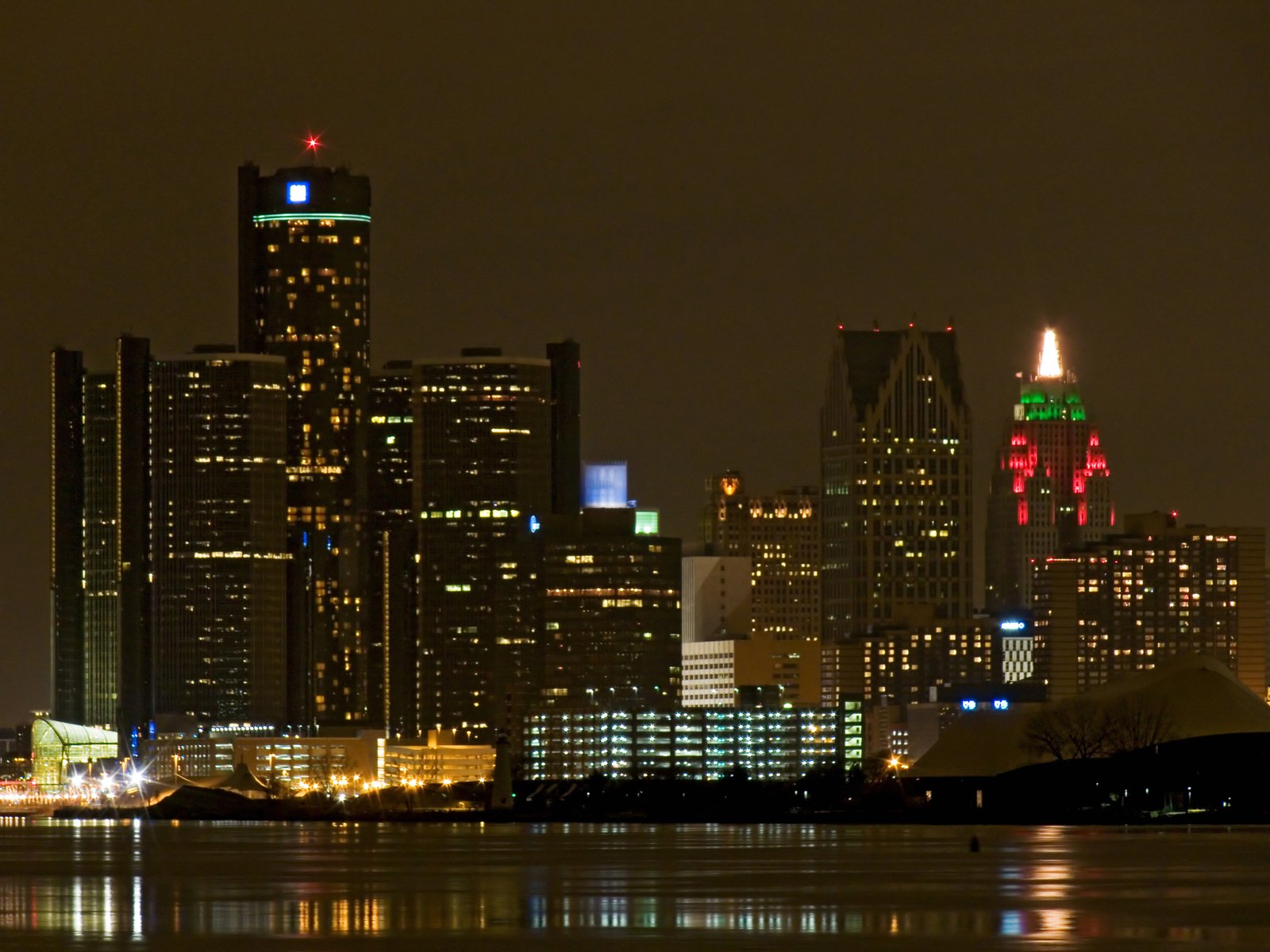 the skyscrs of this city are lit up in red, white and blue