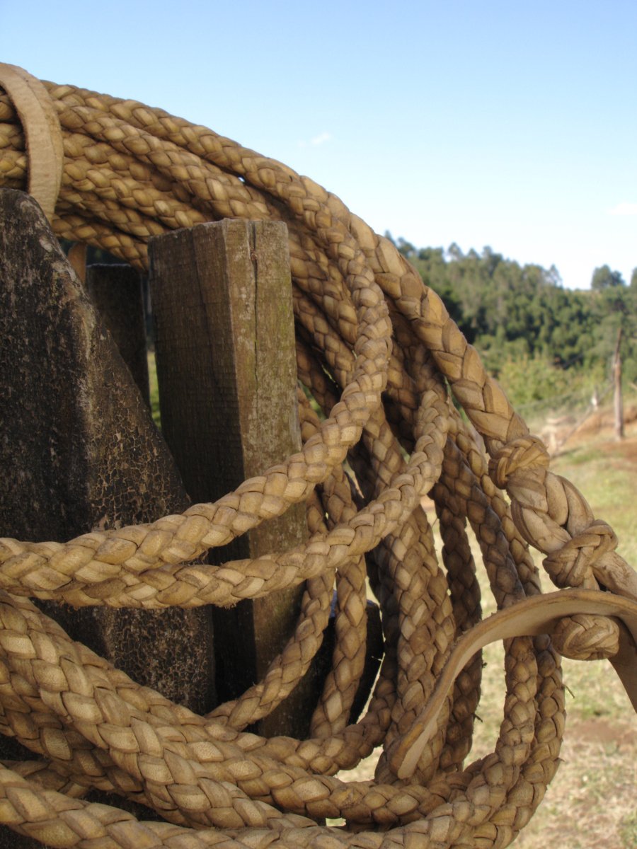 two ropes with nozzles on them are tied to a wooden board