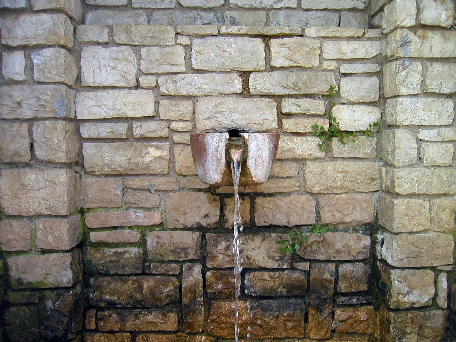 water flowing from the inside of a wall with no water running