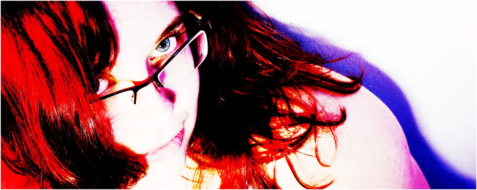 woman in glasses making face with red hair