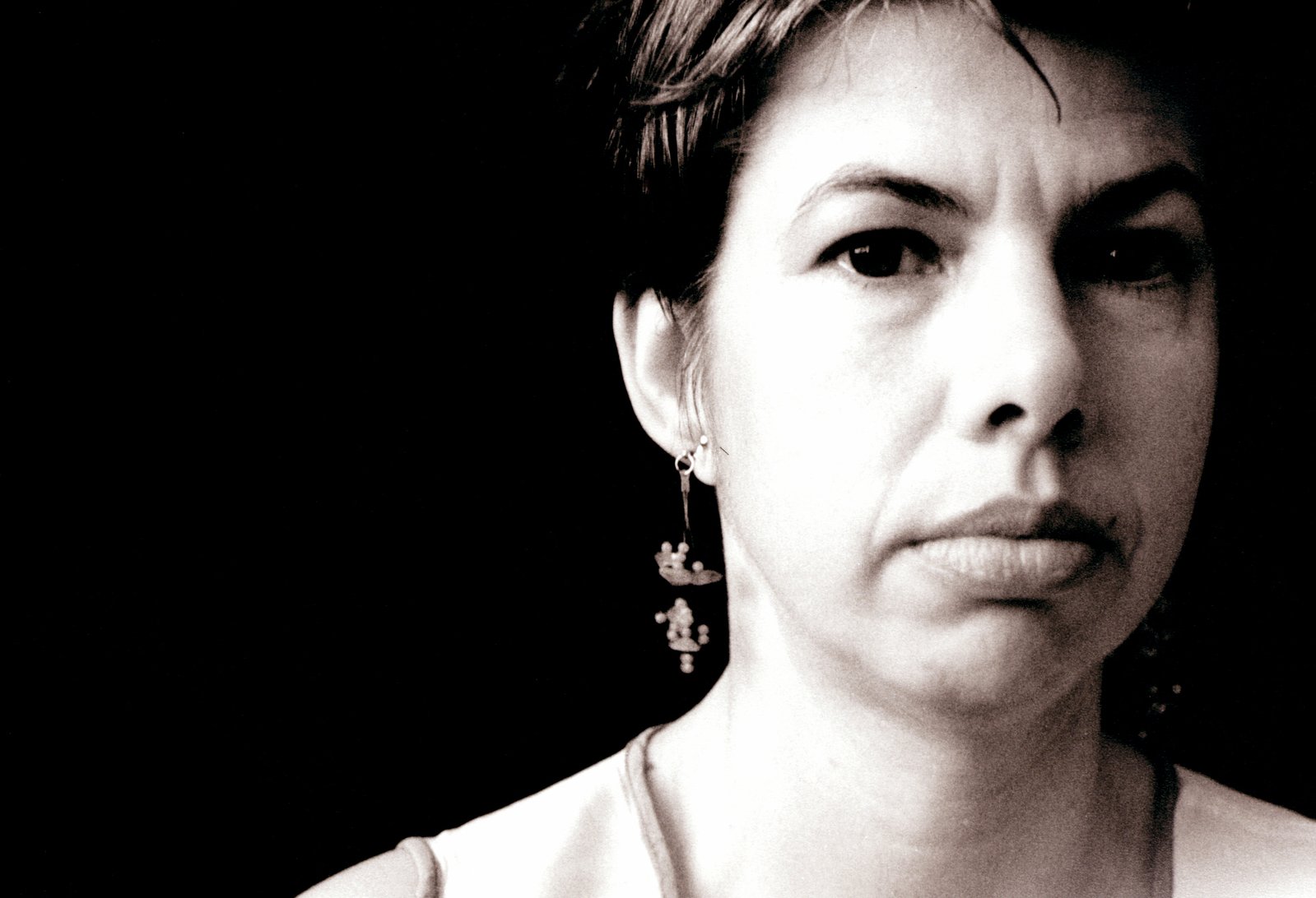 a women wearing some earring's in black and white