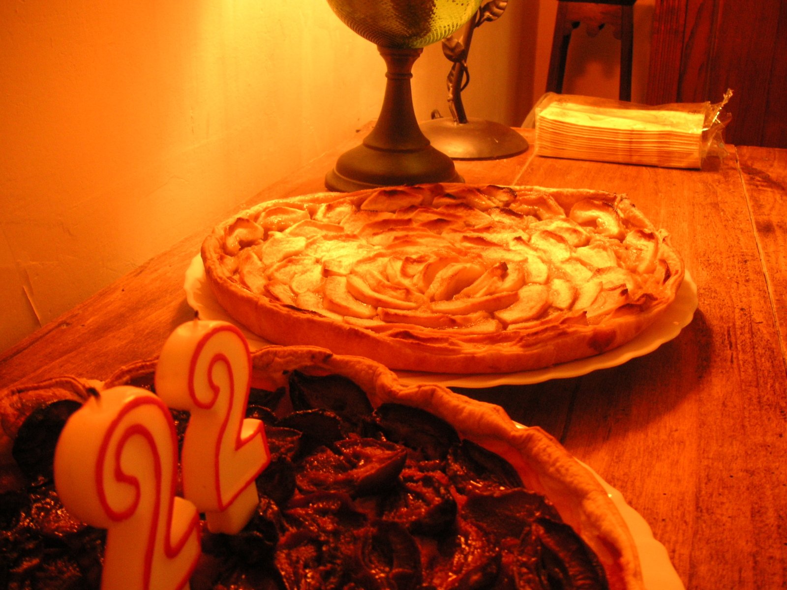 a close up of two pies on a wooden table