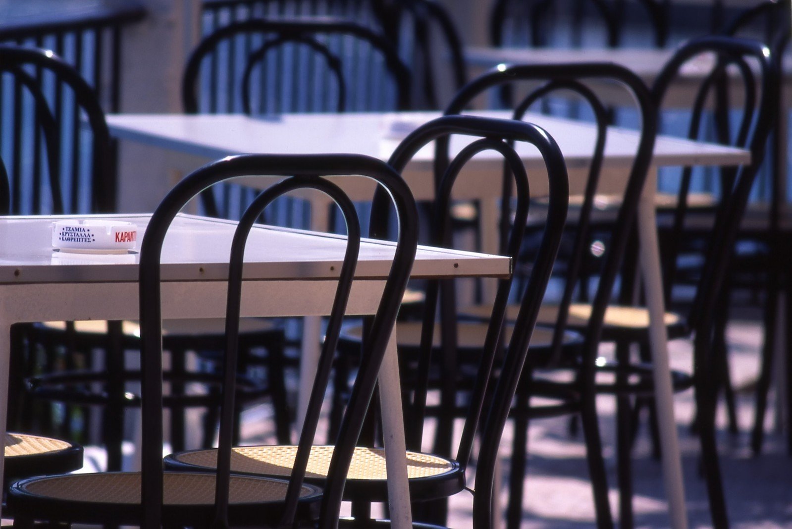 a table and several chairs with a sign on the table