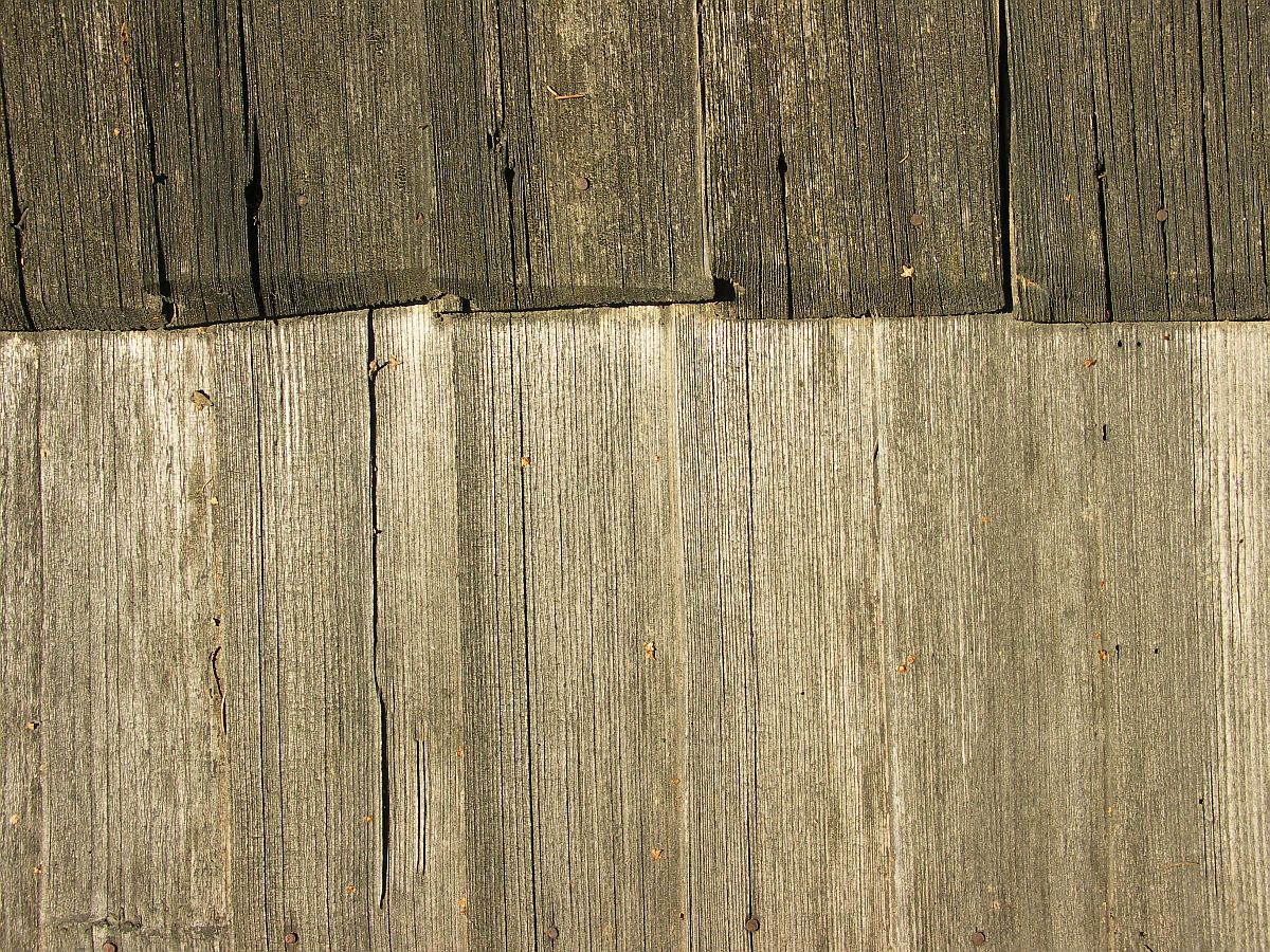 the top half of a wooden paneled wall