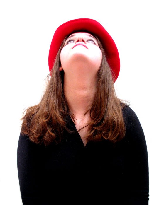 a woman wearing a red hat looking upward